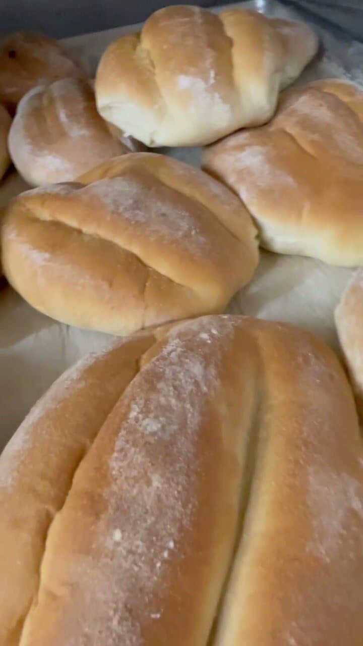 Freshly baked teleras showing the two grooves that divide each roll into three lobes